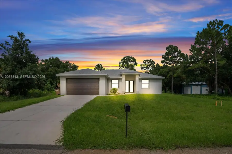 Front exterior of a new home in , Lehigh Acres, FL, highlighting curb appeal (Image 23). Front exterior of a new home in , Lehigh Acres, FL, highlighting curb appeal (Image 23).