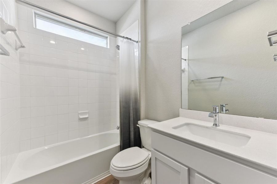 Full bathroom featuring shower / bathtub combination with curtain and vanity Full bathroom featuring shower / bathtub combination with curtain and vanity