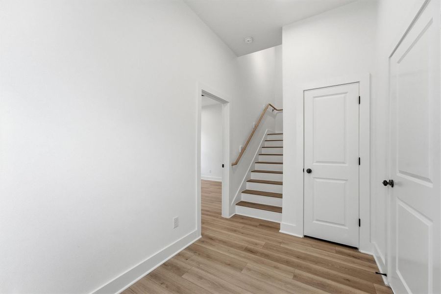 Your new chapter starts right here. A bright, open entryway with luxury vinyl plank flooring, and clean white walls sets a welcoming tone from the moment you walk through the door. Guest bedroom located straight ahead. Your new chapter starts right here. A bright, open entryway with luxury vinyl plank flooring, and clean white walls sets a welcoming tone from the moment you walk through the door. Guest bedroom located straight ahead.
