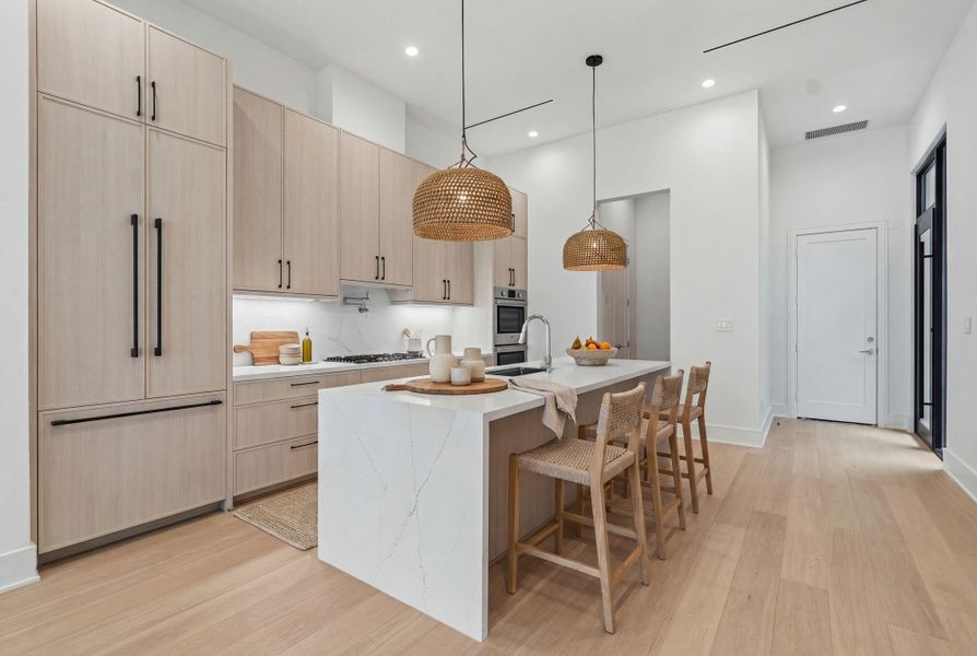 Timeless quartz countertops with waterfall edge. *virtually staged