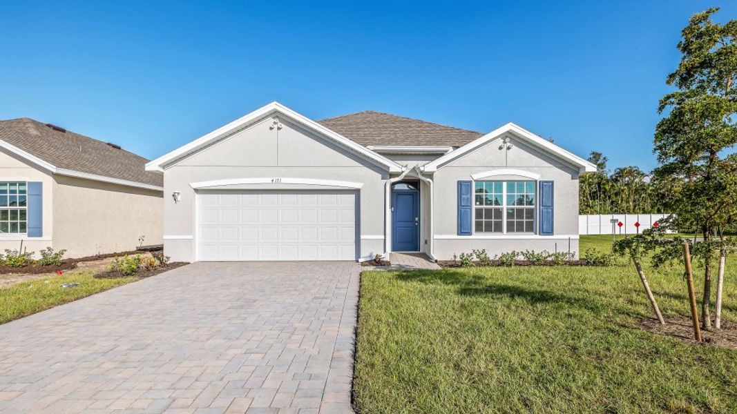 Front exterior of a new home in Coral Bay - Express & Tradition, North Fort Myers, FL, highlighting curb appeal (Image 1). Front exterior of a new home in Coral Bay - Express & Tradition, North Fort Myers, FL, highlighting curb appeal (Image 1).