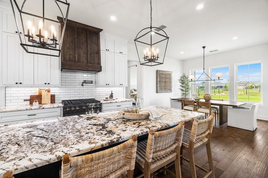 Virtually staged Kitchen featuring pendant lighting, white cabinets, 6 burner gas range, built-in oven, microwave and refrigerator Virtually staged Kitchen featuring pendant lighting, white cabinets, 6 burner gas range, built-in oven, microwave and refrigerator