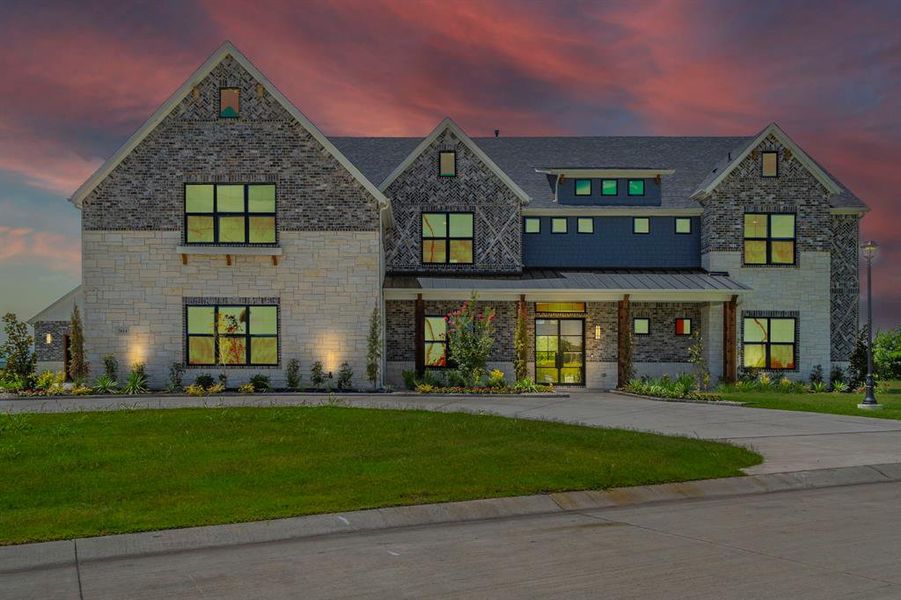 View of front of house with a standing seam roof, stone siding, a front yard, and a shingled roof View of front of house with a standing seam roof, stone siding, a front yard, and a shingled roof