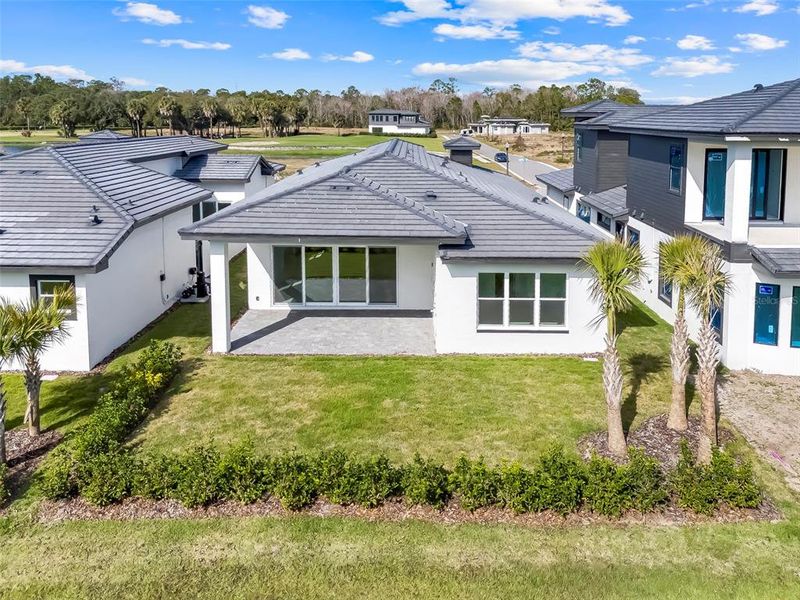 Exterior details and patio area of a home in Hampton Green at Providence, Davenport (Image 28).