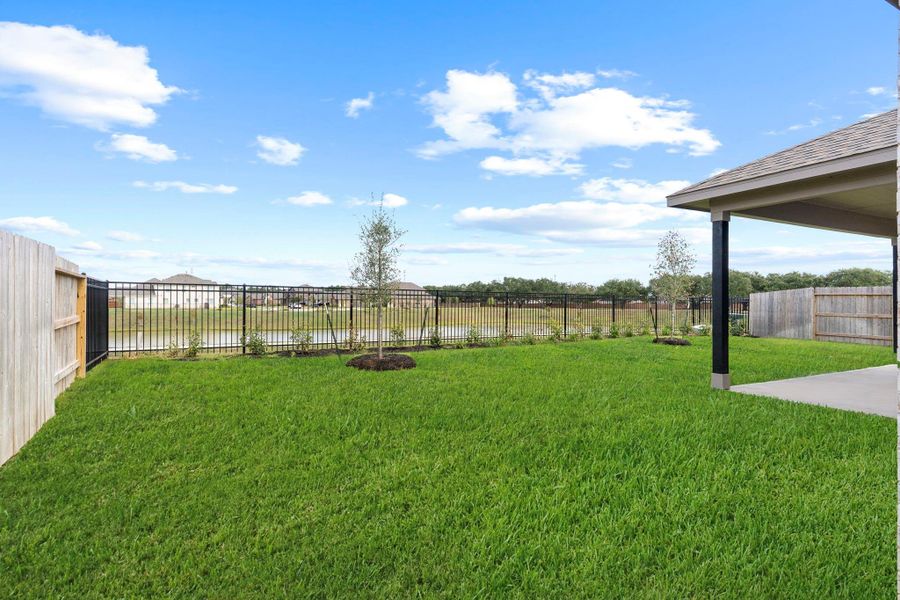 Scenic backyard view facing the lake—enjoy peaceful mornings or evening sunsets with nature as your backdrop. Scenic backyard view facing the lake—enjoy peaceful mornings or evening sunsets with nature as your backdrop.