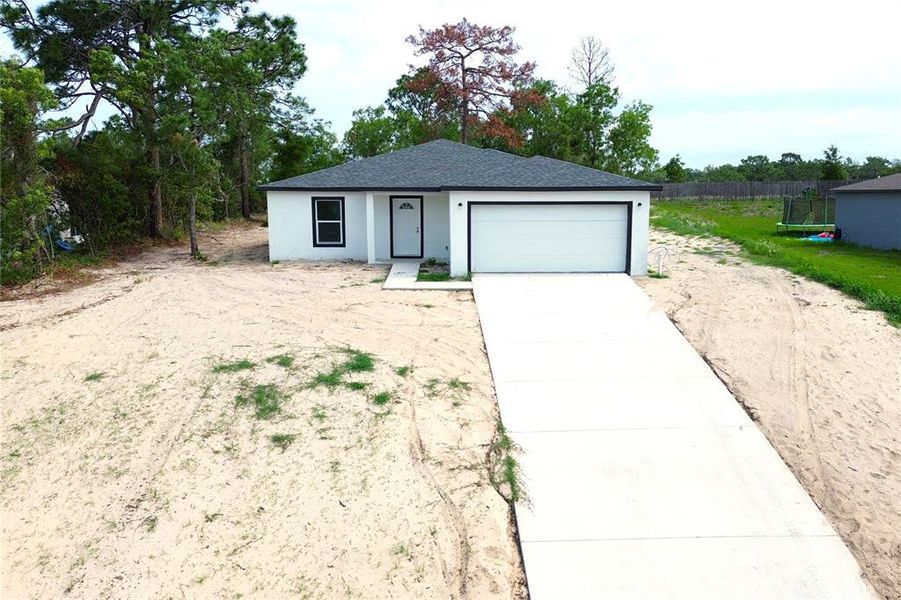 Front exterior of a new home in , Spring Hill, FL, highlighting curb appeal (Image 24).