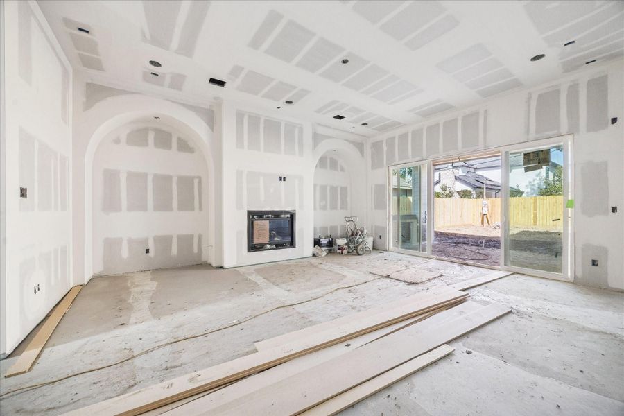 The primary living area showcases impressive ceiling height and an open layout anchored by a statement fireplace with built-in's on either side. The primary living area showcases impressive ceiling height and an open layout anchored by a statement fireplace with built-in's on either side.