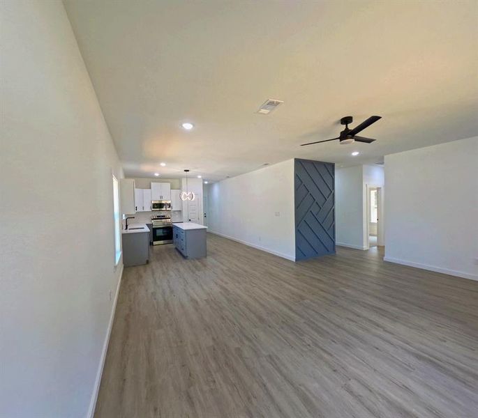 Unfurnished living room featuring light wood-style flooring, recessed lighting, and ceiling fan Unfurnished living room featuring light wood-style flooring, recessed lighting, and ceiling fan