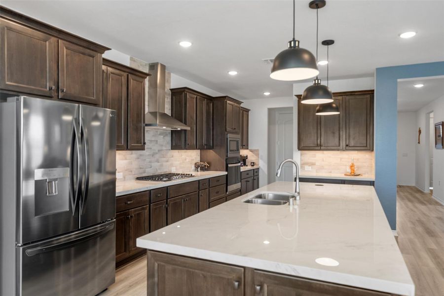 Pendent lights and backsplash are also an upgrade included in this home.