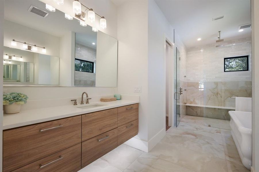 Underlit floating vanities in primary bath