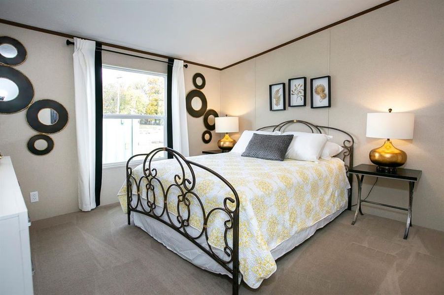 Bedroom featuring carpet flooring and crown molding