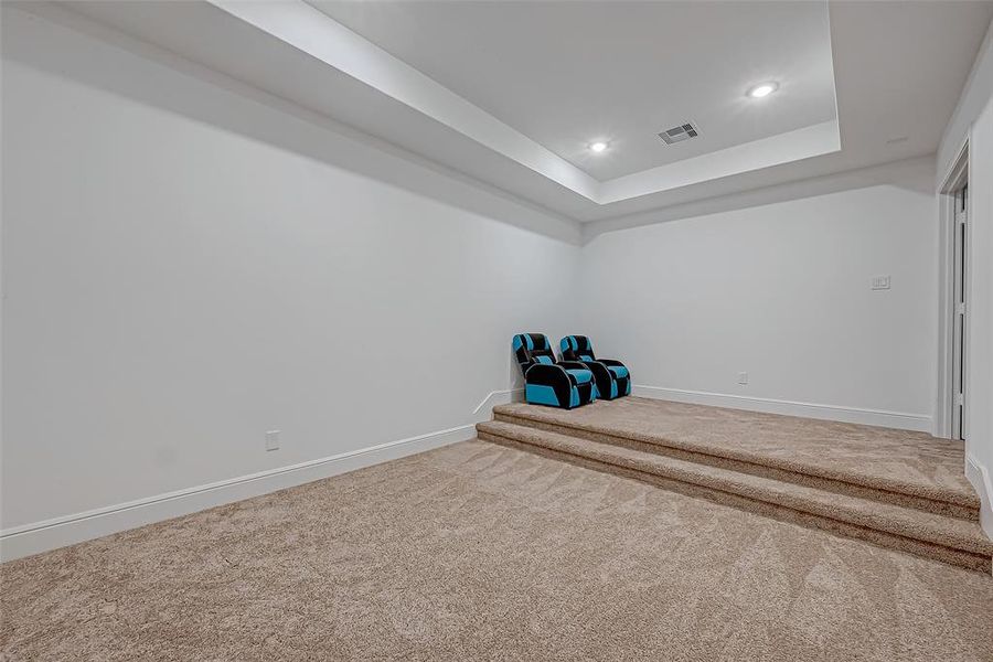 Upstairs Media Room: Theater-style with tray ceiling, pocket lighting, and double-door entry.