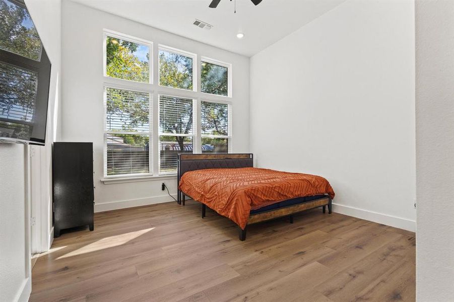 Bedroom featuring wood finished floors, ceiling fan, and recessed lighting