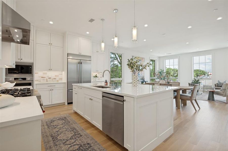 Large kitchen island featuring an efficient prep space and bar seating perfect for casual dining. Large kitchen island featuring an efficient prep space and bar seating perfect for casual dining.