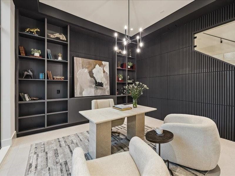 The office features a large storage room concealed by a hidden door that seamlessly blends into the wall design, maintaining a sleek and cohesive look.