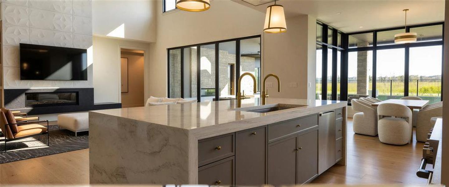 Kitchen with open floor plan, a kitchen island with sink, hanging light fixtures, and stainless steel appliances