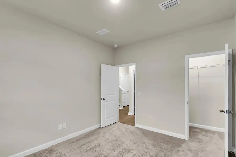 Each secondary bedroom offers comfort and storage.