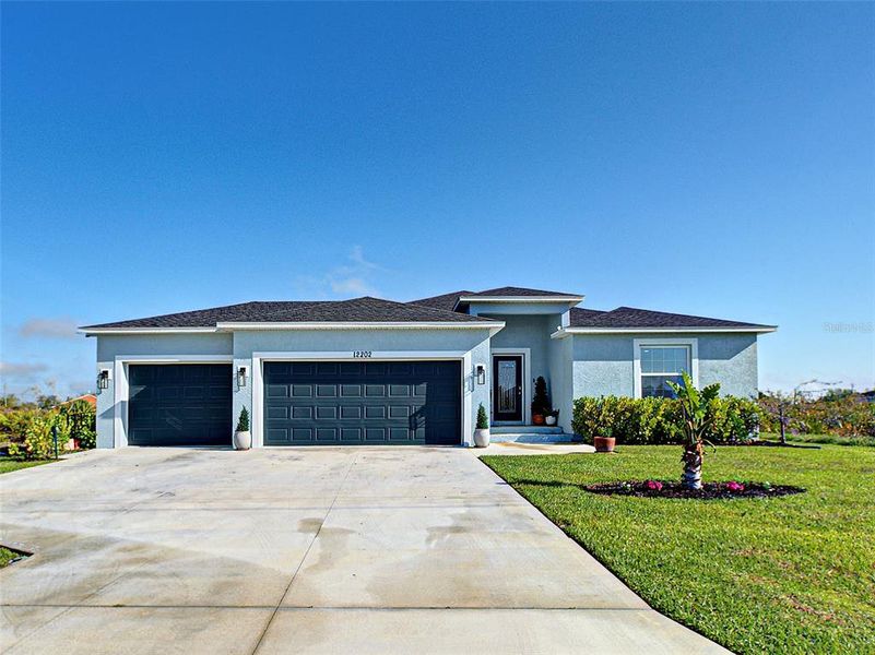 Front exterior of a new home in , Port Charlotte, FL, highlighting curb appeal (Image 1). Front exterior of a new home in , Port Charlotte, FL, highlighting curb appeal (Image 1).