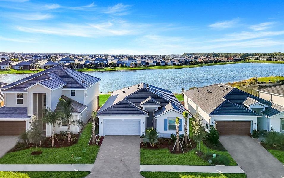 Front exterior of a new home in Hampton Lakes at River Hall, Alva, FL, highlighting curb appeal (Image 16).
