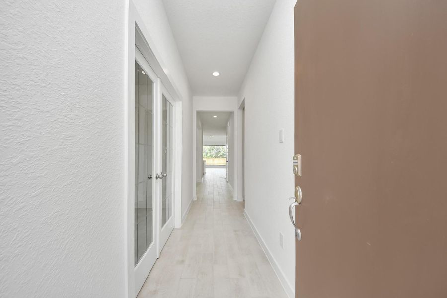 As you step into the threshold of this luxurious home, you'll soon be welcomed by an elegant glass door (to be installed). Inside, soaring ceilings amplify the spaciousness, while the refined wood-look tile flooring and oversized baseboards exude sophistication and charm.