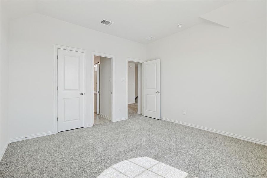 Unfurnished bedroom featuring light carpet