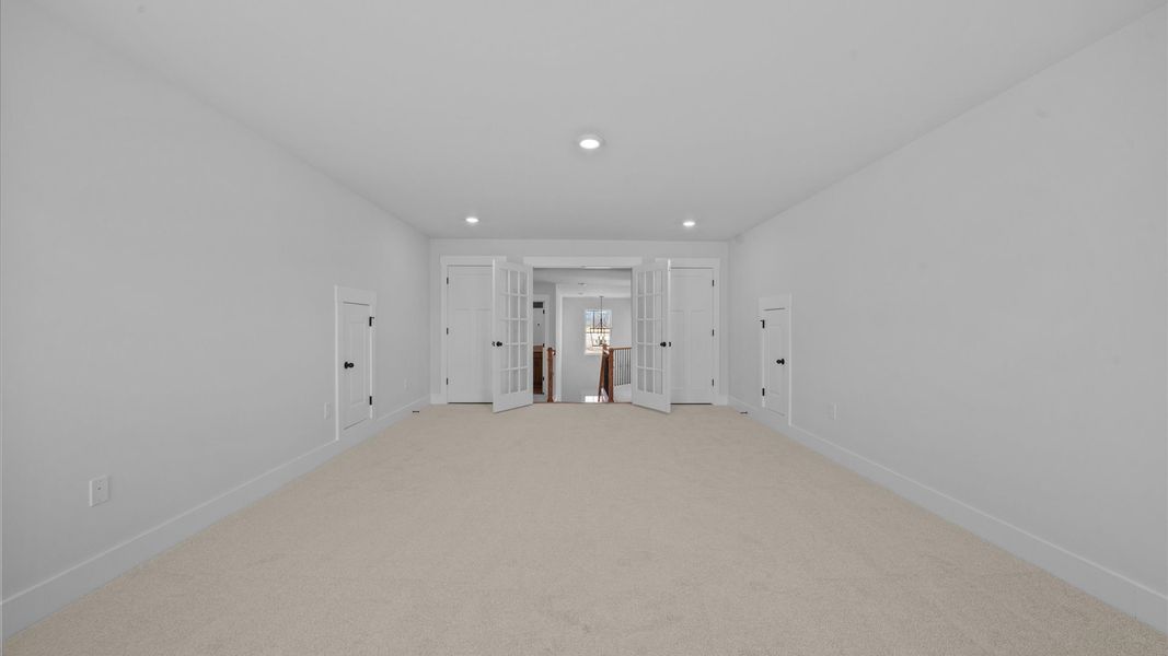 Vibrant carpeted bonus room offering flexibility as a study nook, game room, or second family space