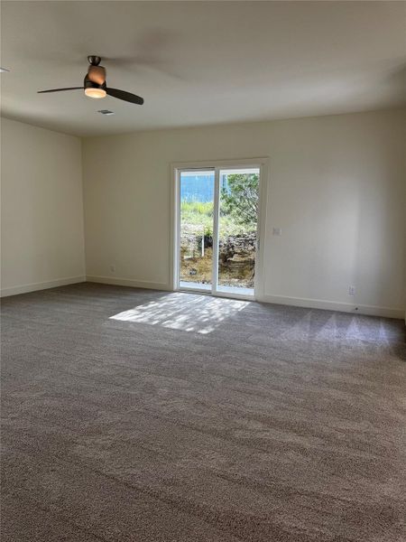 Unfurnished room with carpet and ceiling fan Unfurnished room with carpet and ceiling fan