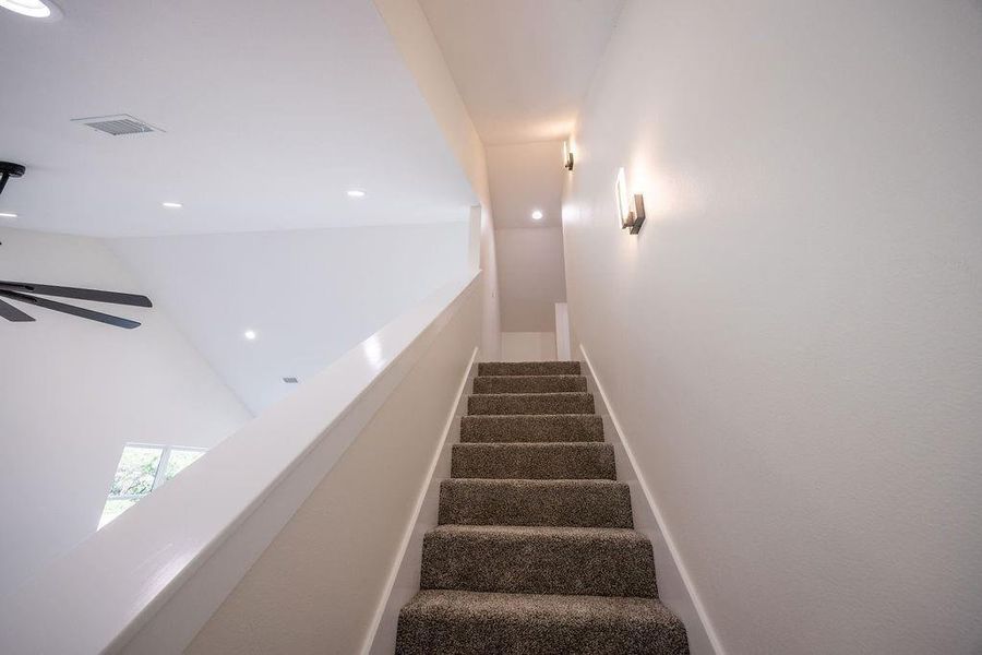 Staircase featuring recessed lighting and a ceiling fan