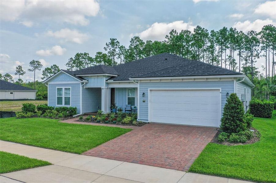 Front exterior of a new home in Reverie at Palm Coast, Palm Coast, FL, highlighting curb appeal (Image 25).