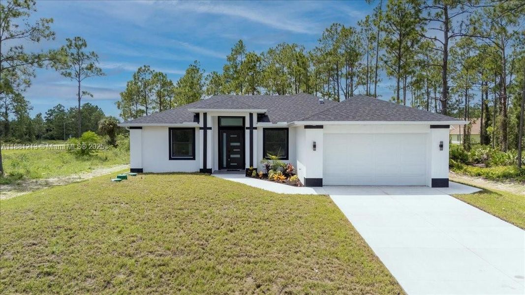Front exterior of a new home in , Lehigh Acres, FL, highlighting curb appeal (Image 24). Front exterior of a new home in , Lehigh Acres, FL, highlighting curb appeal (Image 24).