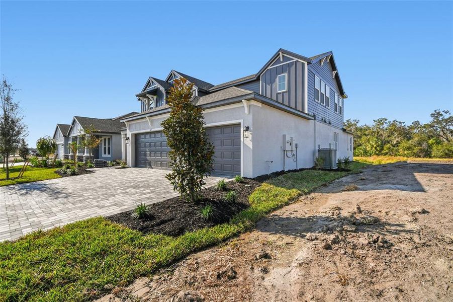Front exterior of a new home in Creeks Edge at Twin Rivers, Parrish, FL, highlighting curb appeal (Image 26).