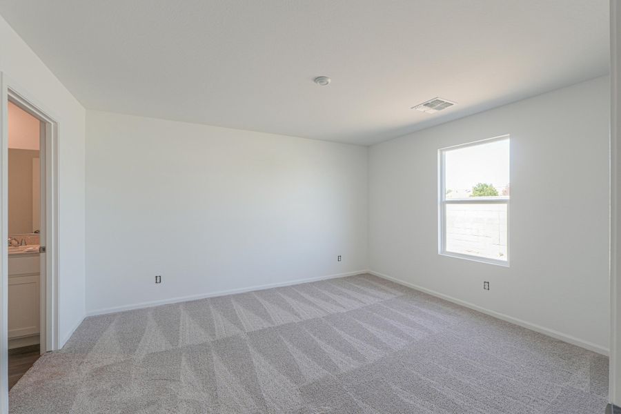 A room with a carpet and a window. A room with a carpet and a window.