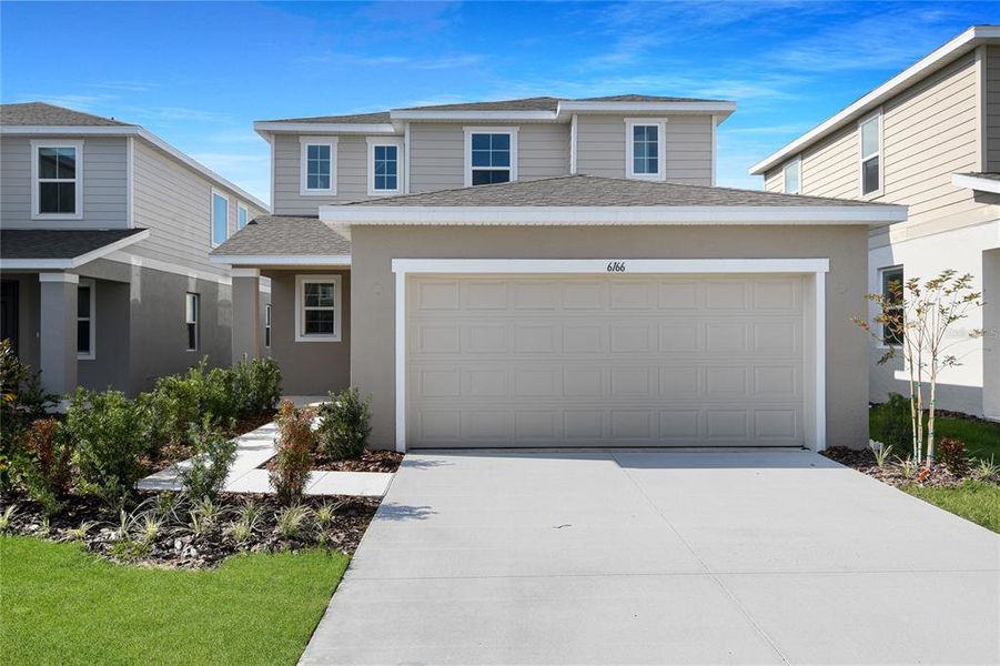 Front exterior of a new home in Seasons at Scenic Terrace, Lake Hamilton, FL, highlighting curb appeal (Image 2). Front exterior of a new home in Seasons at Scenic Terrace, Lake Hamilton, FL, highlighting curb appeal (Image 2).