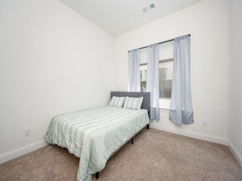 Bedroom with carpet, baseboards, and visible vents