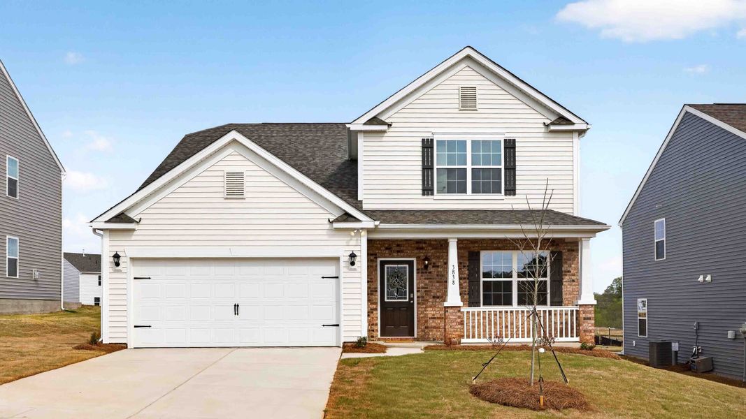 Front exterior of a new home in Secrest Commons, Monroe, NC, highlighting curb appeal (Image 1). Front exterior of a new home in Secrest Commons, Monroe, NC, highlighting curb appeal (Image 1).