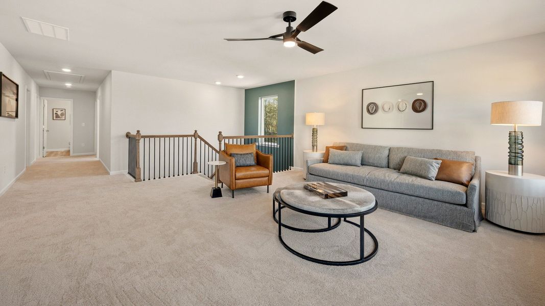 Spacious loft area with ceiling fan and carpet Spacious loft area with ceiling fan and carpet