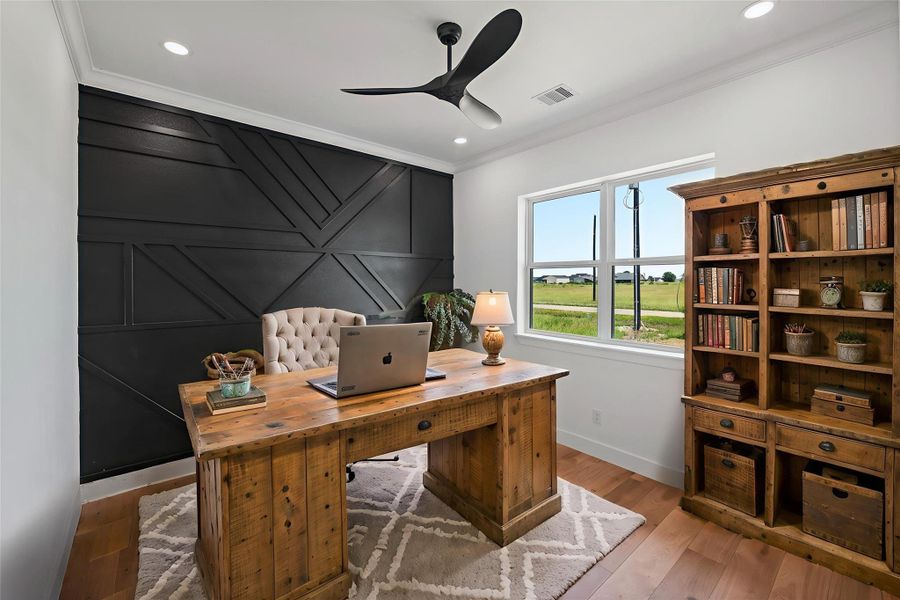 Stylish and functional office space with modern accents and a serene view, perfect for productivity. DIGITALLY STAGED