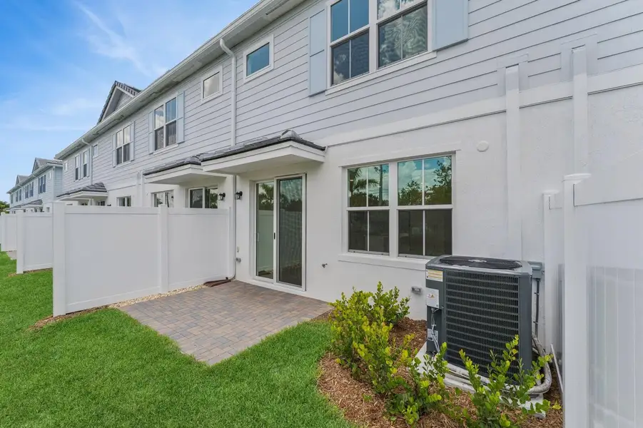 Front exterior of a new home in Salerno Reserve Townhomes, Stuart, FL, highlighting curb appeal (Image 2).