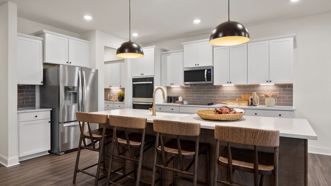 Townsend home plan spacious kitchen with center island, tile backsplash and butler's pantry overlooking family room