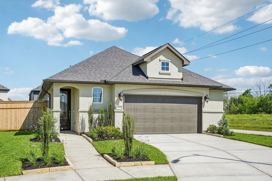 Front exterior of a new home in Sienna 40', Missouri City, TX, highlighting curb appeal (Image 16). Front exterior of a new home in Sienna 40', Missouri City, TX, highlighting curb appeal (Image 16).