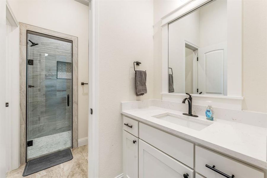 Bathroom with a stall shower and vanity Bathroom with a stall shower and vanity