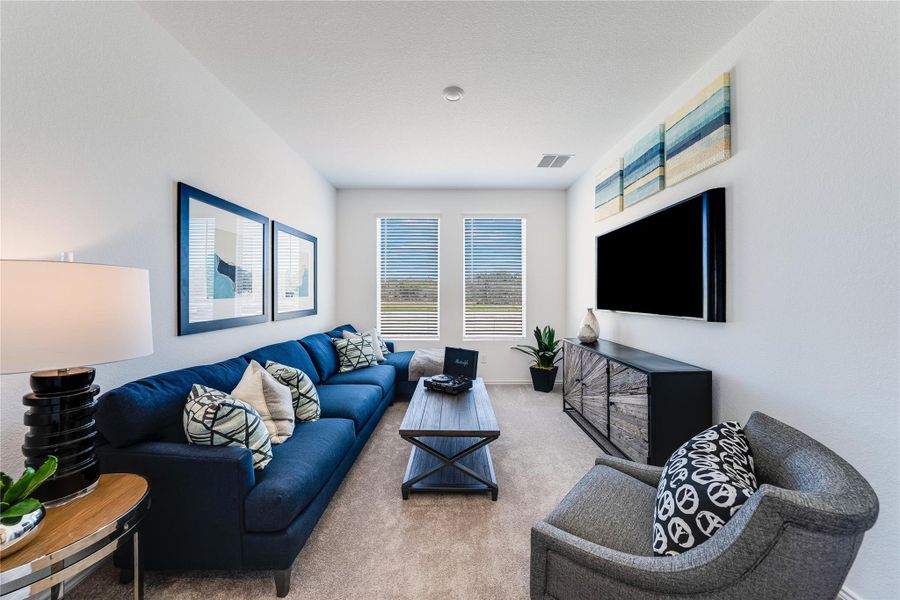 Living area featuring carpet and baseboards