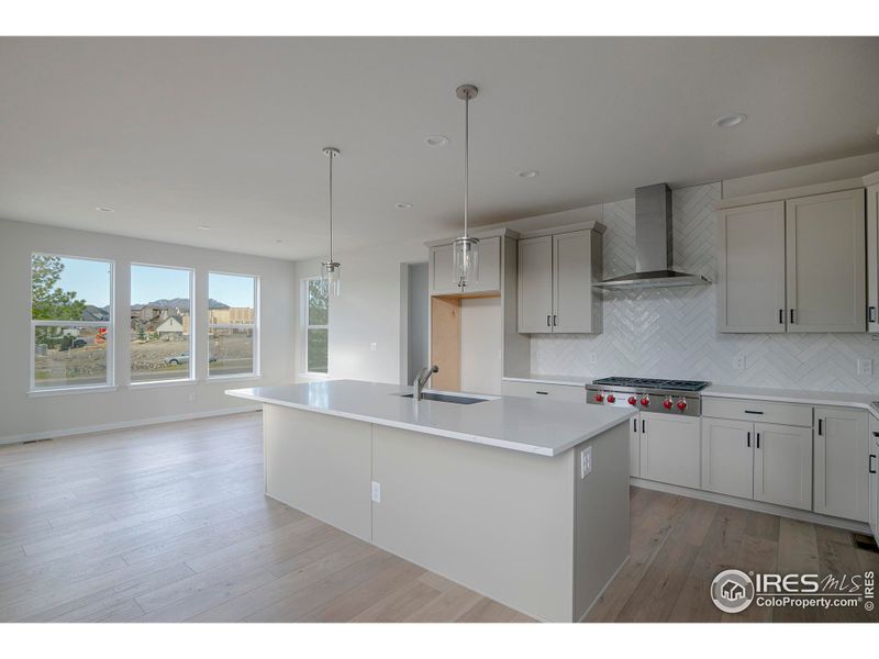 The dining area has large windwos overlooking the backyard and has mountain views