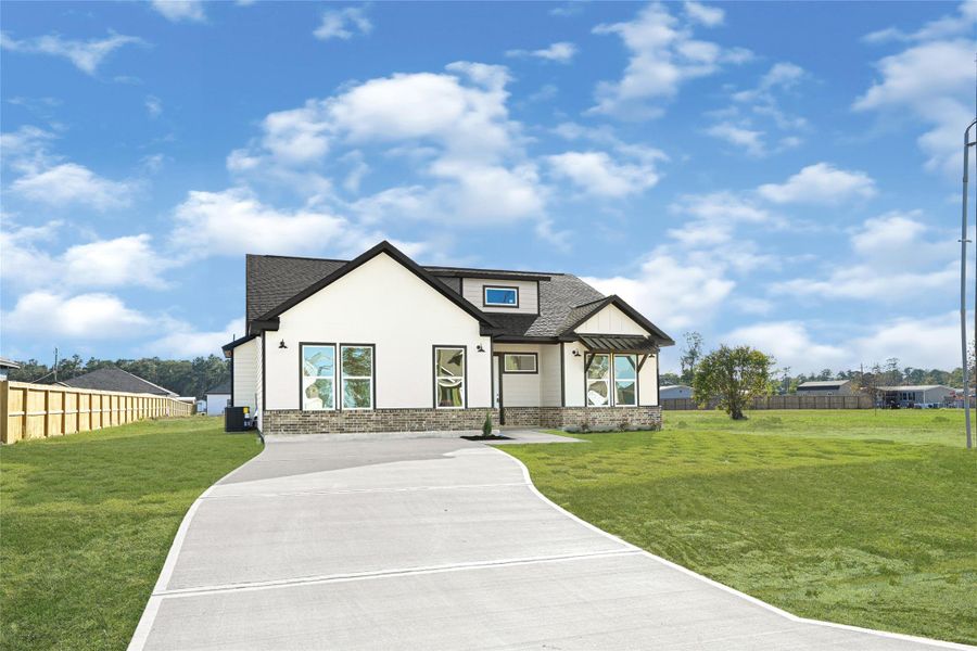 Front exterior of a new home in , Huffman, TX, highlighting curb appeal (Image 24). Front exterior of a new home in , Huffman, TX, highlighting curb appeal (Image 24).