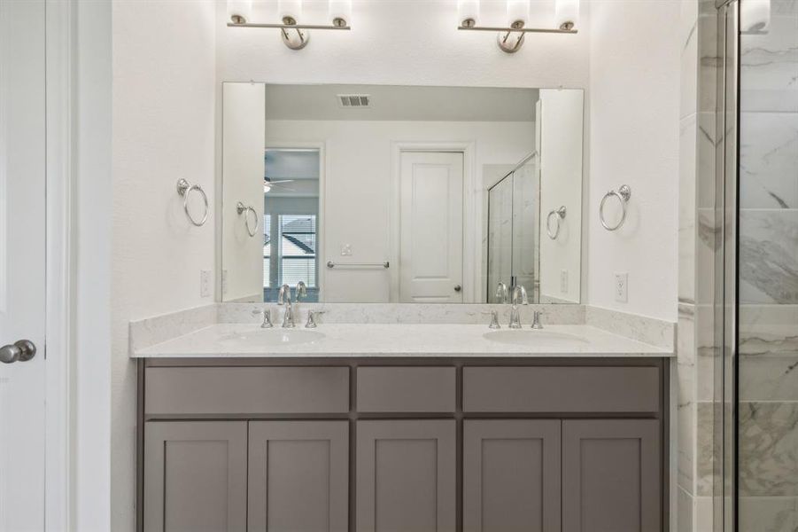 Bathroom with ceiling fan, vanity, and walk in shower