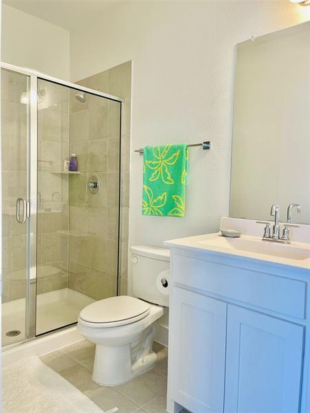 Bathroom with vanity, a stall shower, and light tile patterned floors Bathroom with vanity, a stall shower, and light tile patterned floors