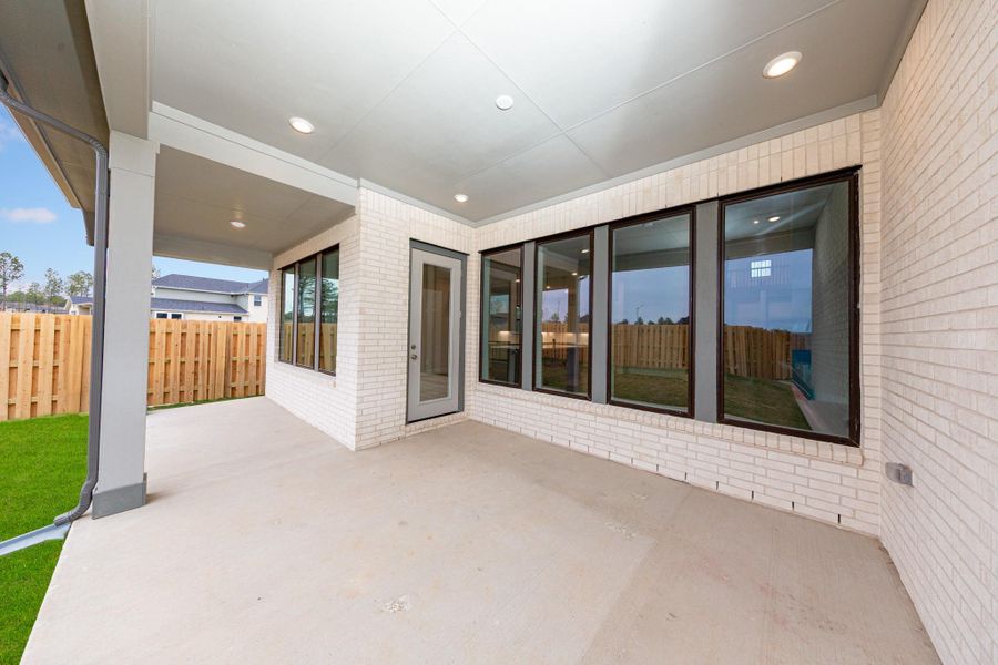 Step outside to the covered rear patio, the perfect extension of your indoor living space for year-round enjoyment.