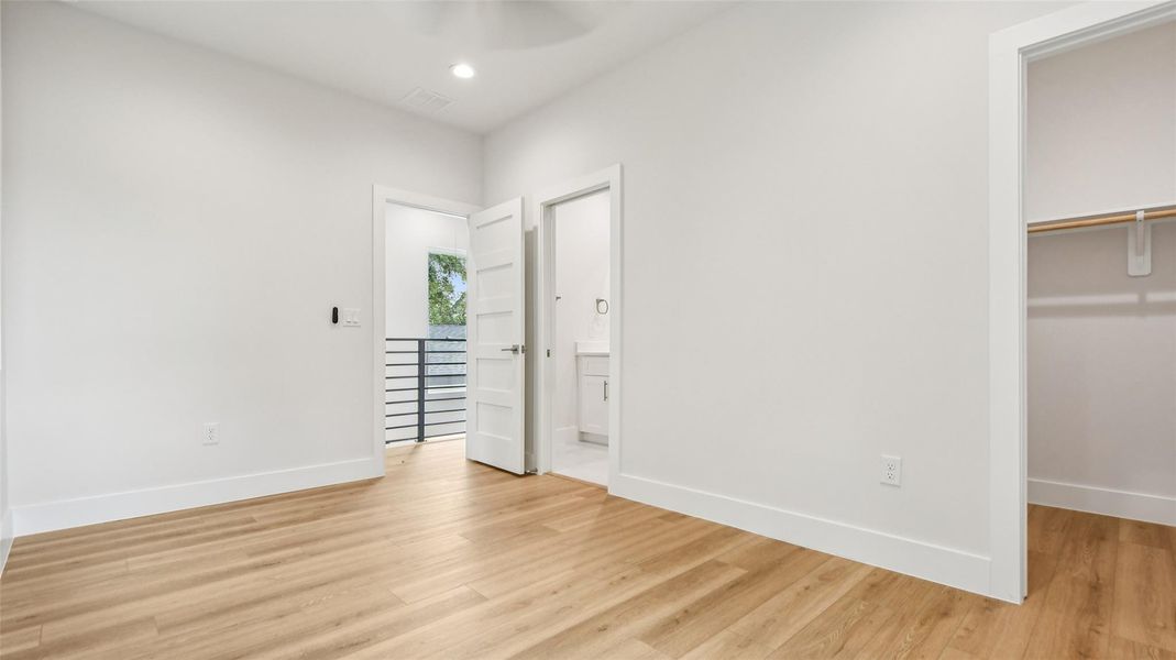 Unfurnished bedroom with a spacious closet, light wood finished floors, recessed lighting, and a ceiling fan Unfurnished bedroom with a spacious closet, light wood finished floors, recessed lighting, and a ceiling fan