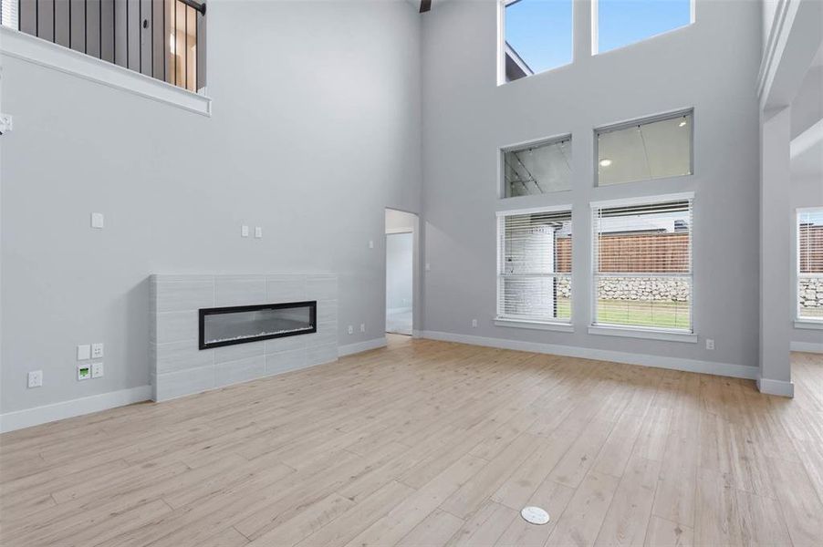 Spacious living room with soaring ceilings, abundant natural light, and an open-concept layout.