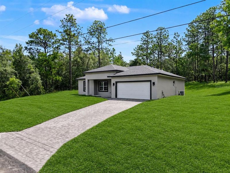 Front exterior of a new home in , Citrus Springs, FL, highlighting curb appeal (Image 27).